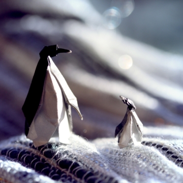 father and son, miniature origami penguins, designed by Eric Joisel